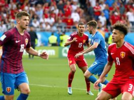 Macedonia U19 players in red competing against Slovakia in blue.