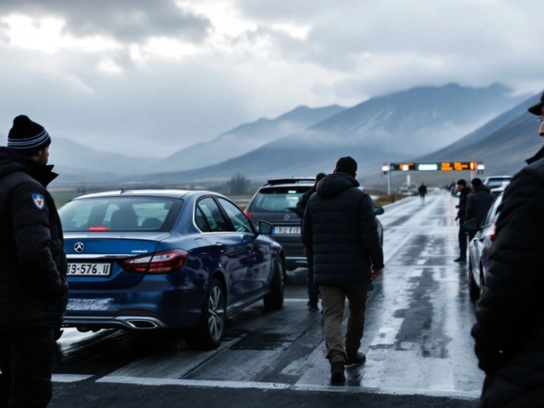 Border crossing with vehicles and officials in Kosovo.