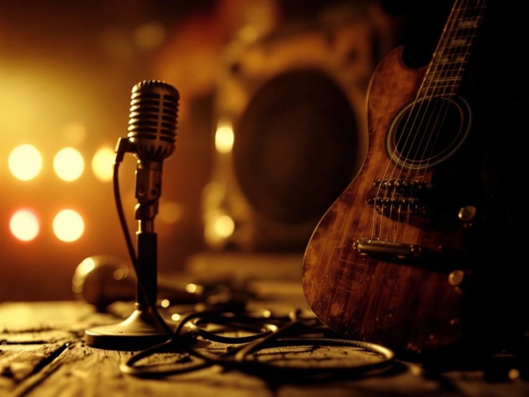 Vintage guitar and microphone in a concert setting.