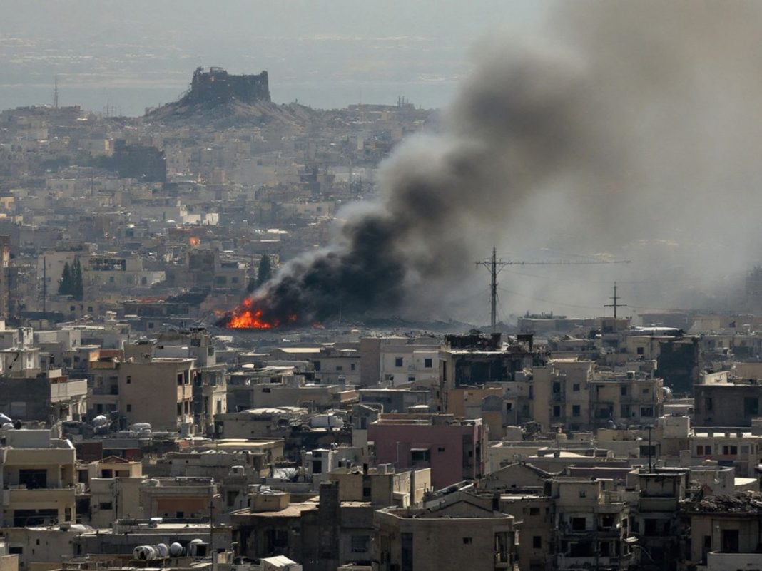 Aerial view of Tyre with smoke and destruction.