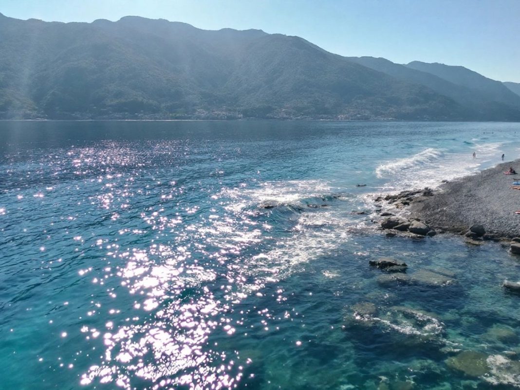 Coastal view of Montenegro with beach and mountains.