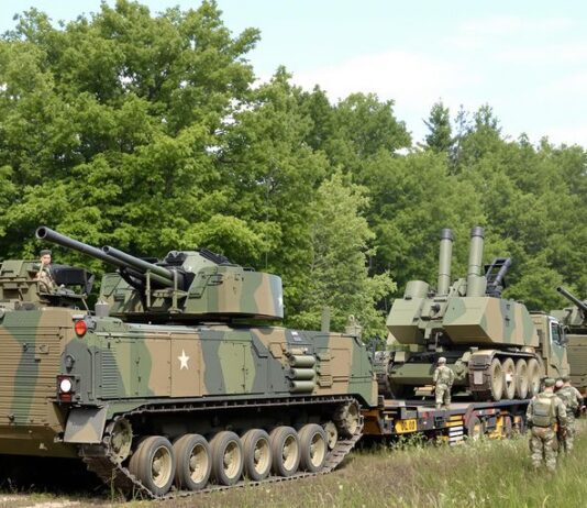 Croatian soldiers deploy artillery in Lithuanian landscape.