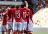 Canadian soccer team celebrates scoring a goal against Romania.