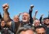 Kosovo war veterans protest with raised fists and determined expressions.