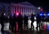 Police arrest masked suspects near Serbian government buildings.
